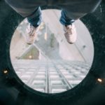 person standing on round clear glass
